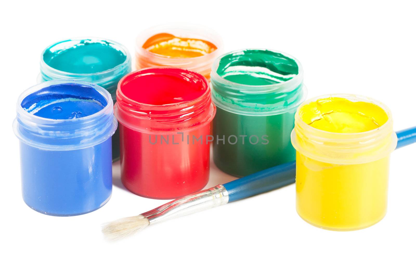 Closeup view of colorful cans with gouache and brush