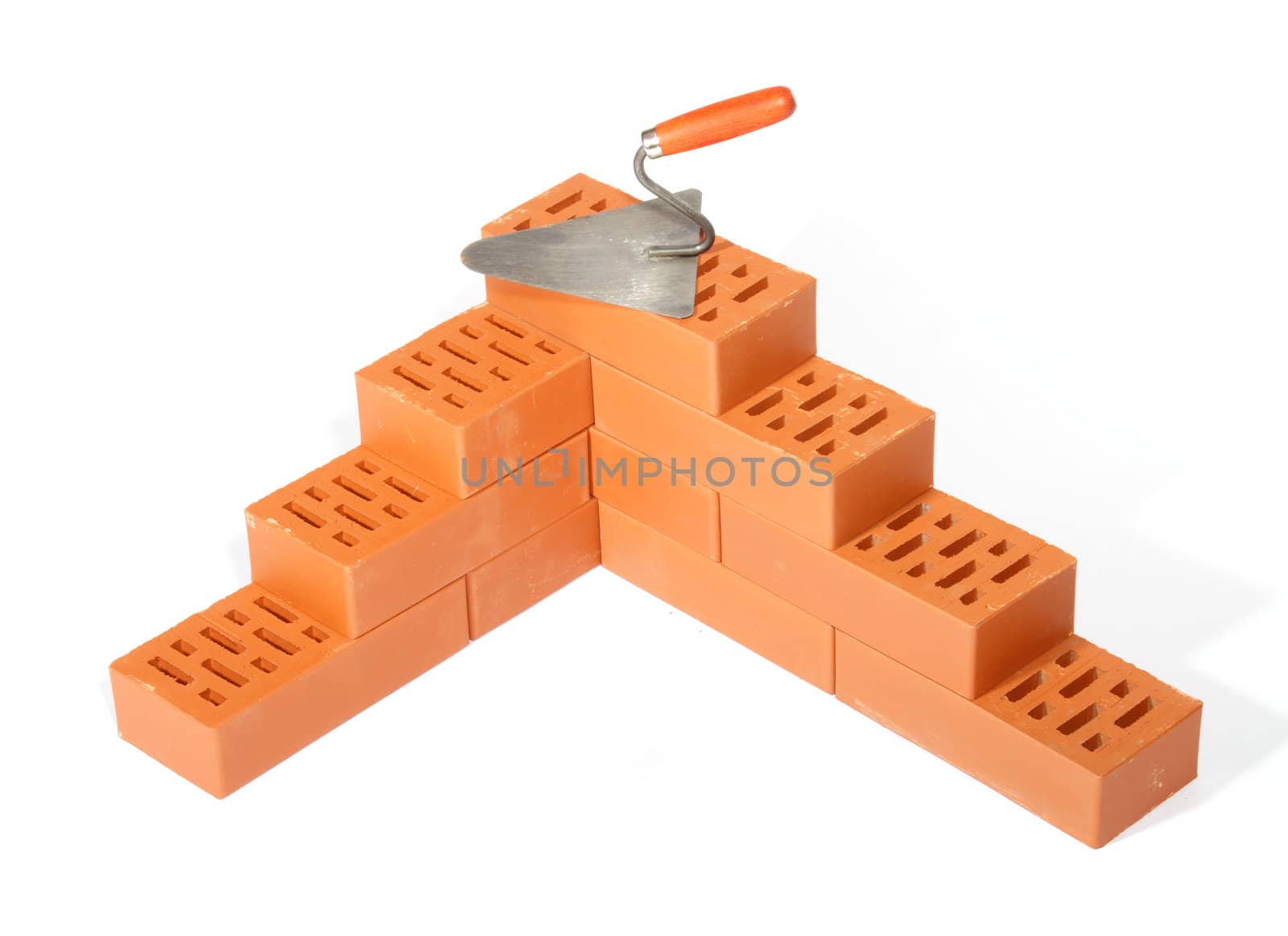 red bricks and trowel, photo on the white background 