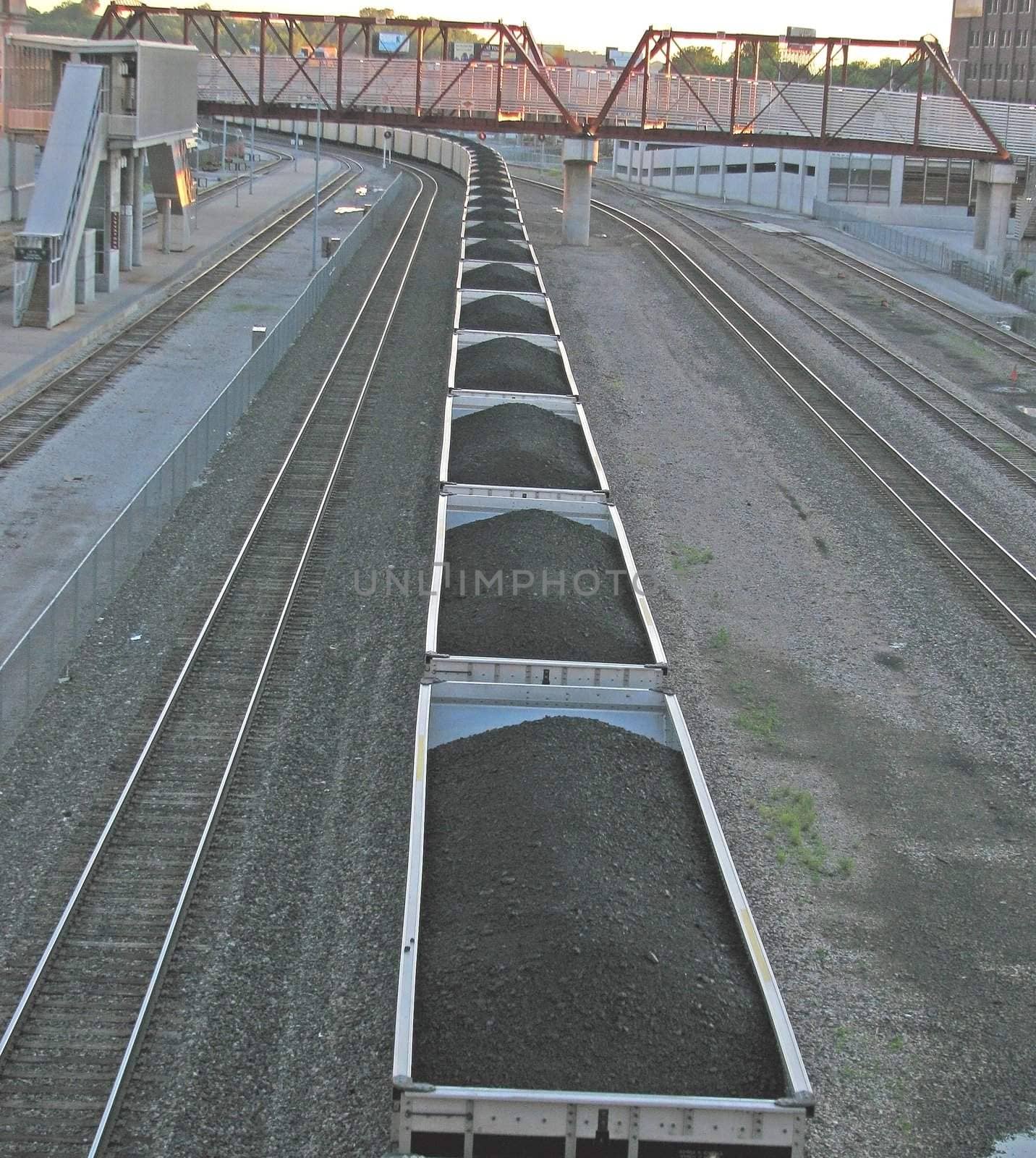 Train carrying coal through a town in the Midwest America.
