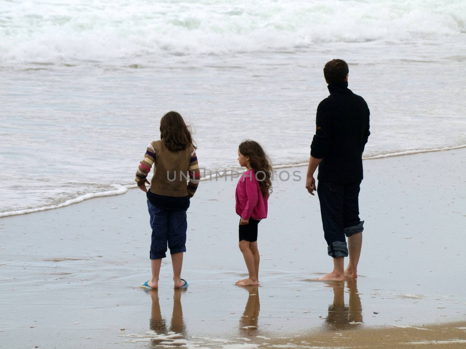 Father and his two daughters  at the beach