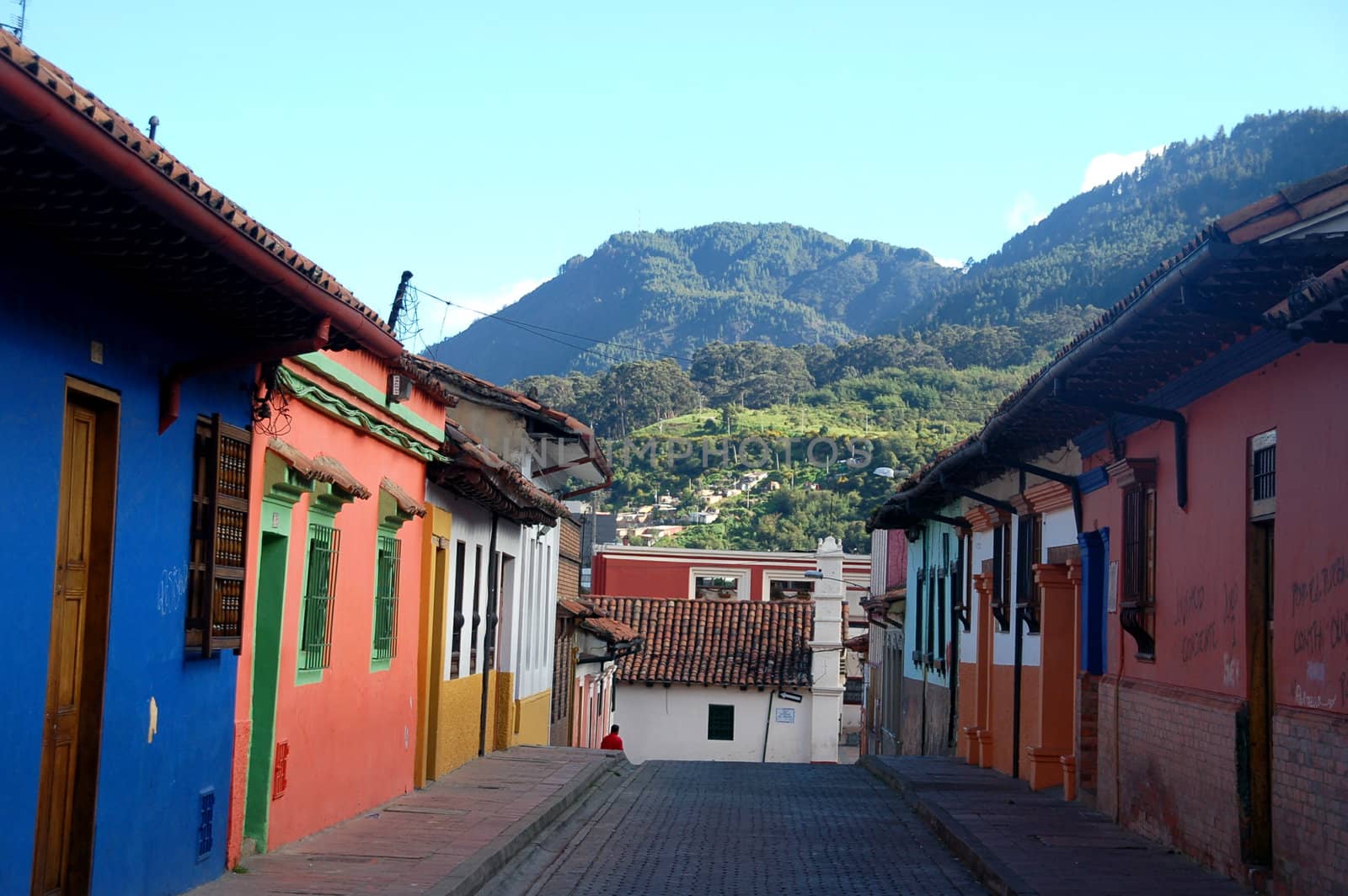 Colourful tiny houses on a narrow cobblestone street in the historic centre of Bogota