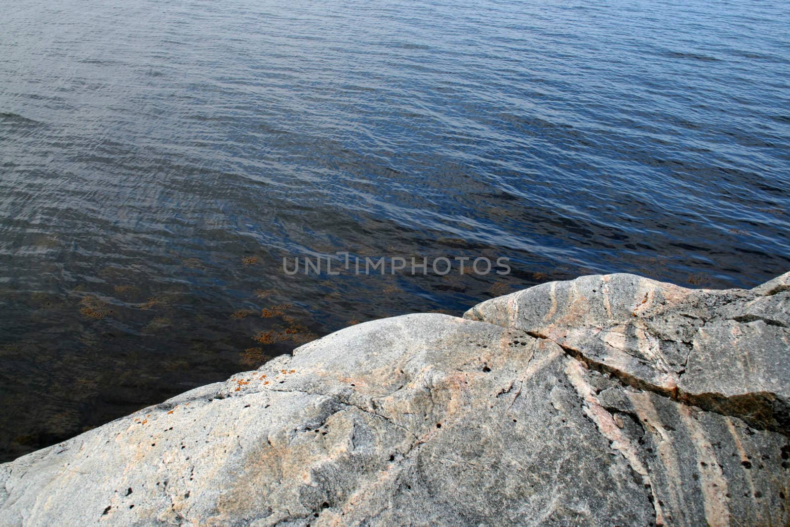 grey rock near calm sea
