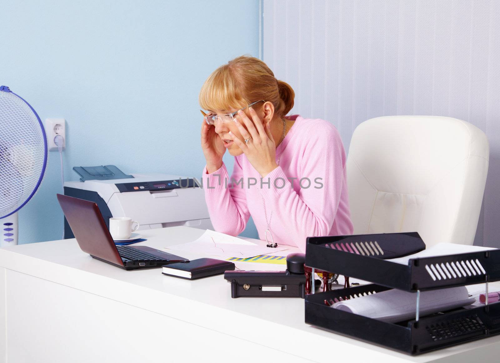 Very busy blonde in the office workplace