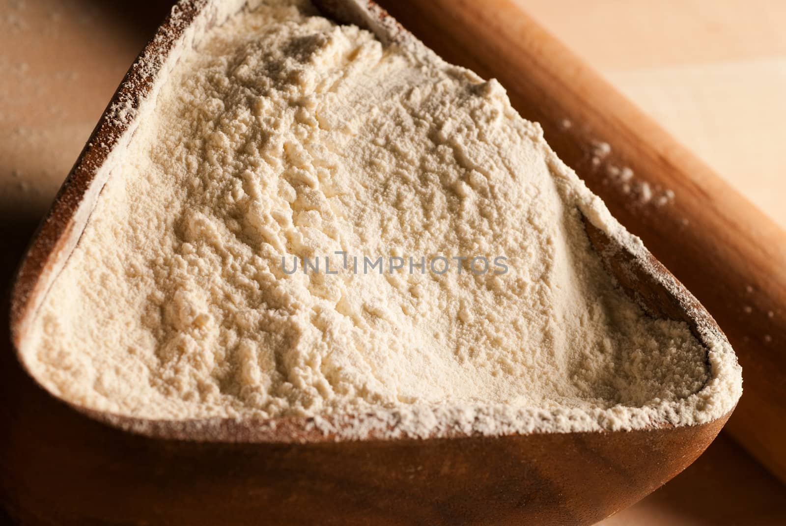 A bakery tray with flour under golden morning sunlight