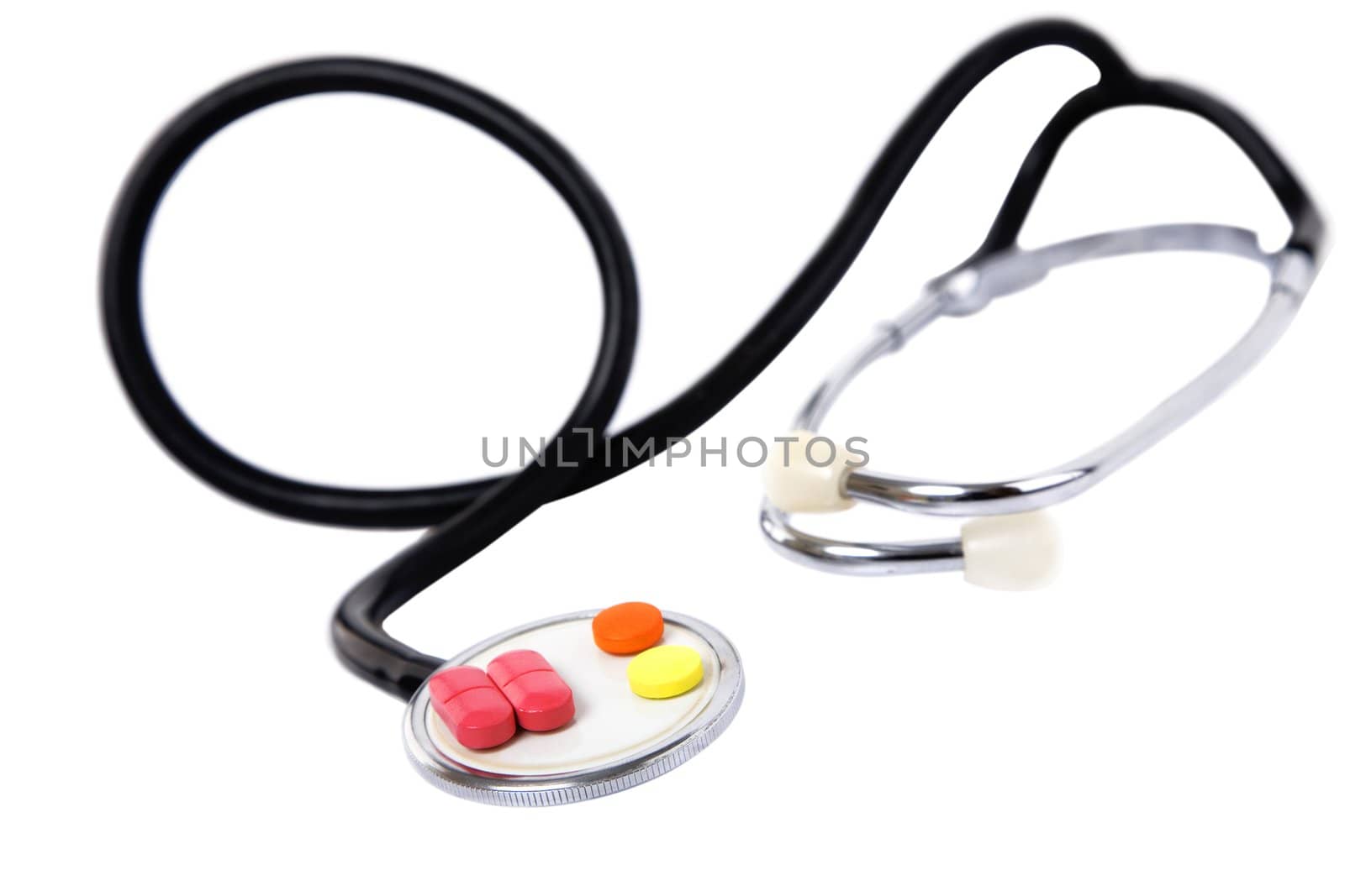 medical concept with colorful pills and stethoscope on white
