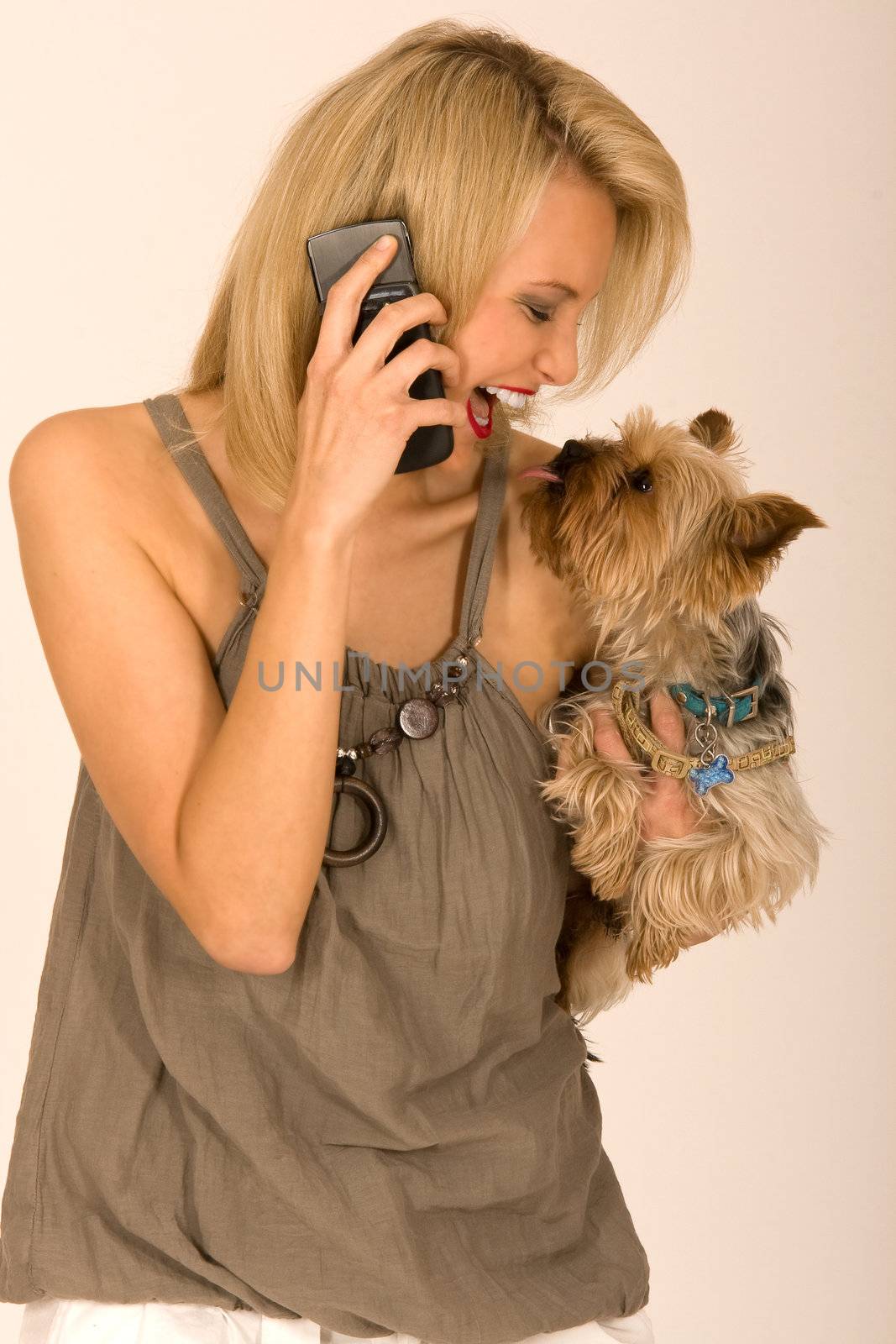 Woman with dog on the phone at arm