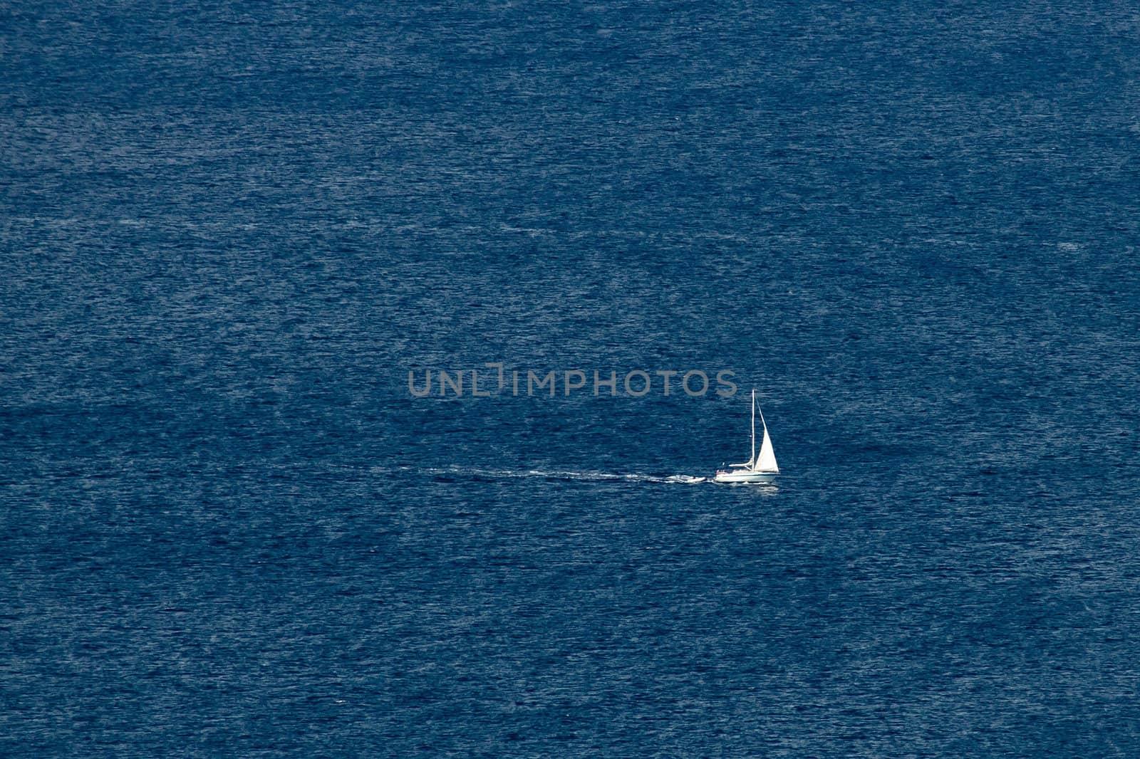 Sailboat on open sea, blue waters