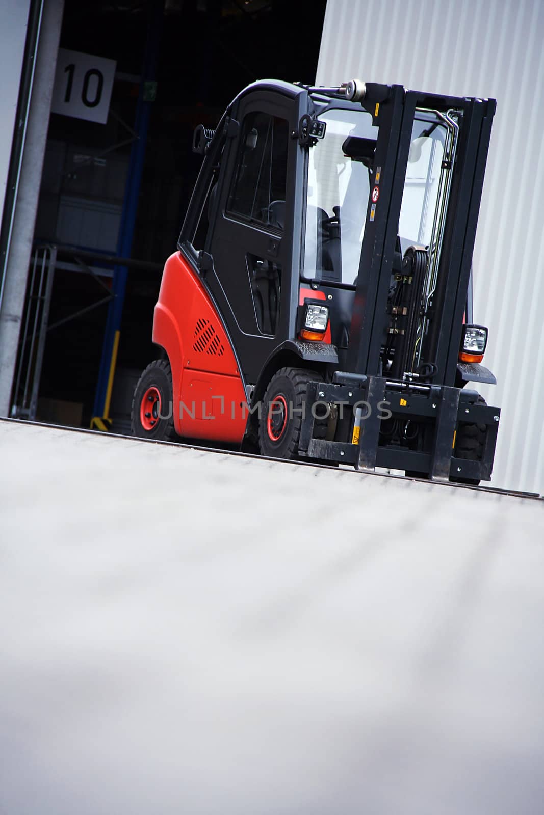 the red forklift in a logistic warehouse with