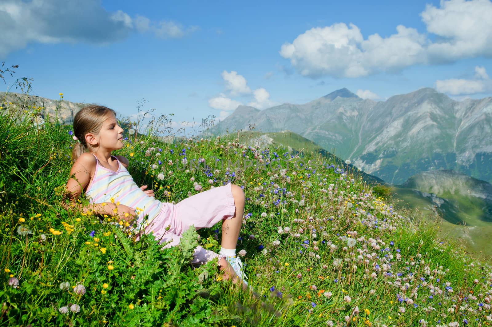 girl lying in a meadow backround Alps by maxoliki