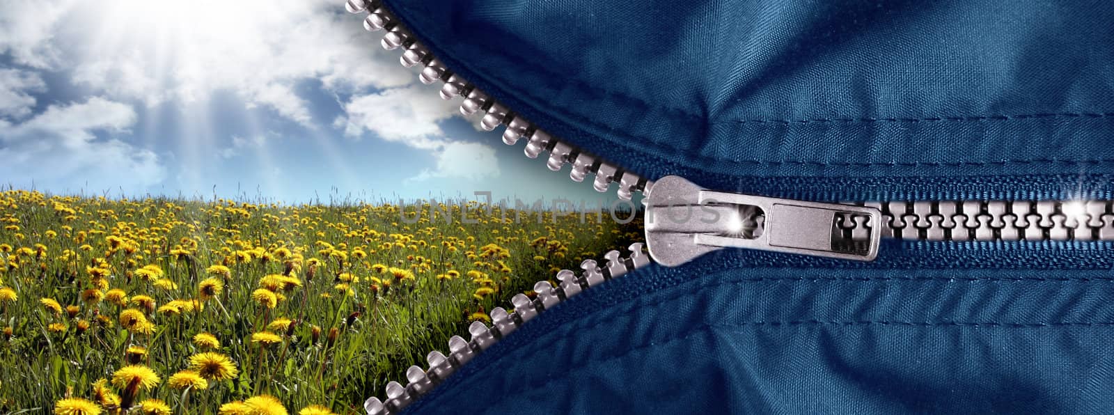 opened zipper with blue sky and meadow