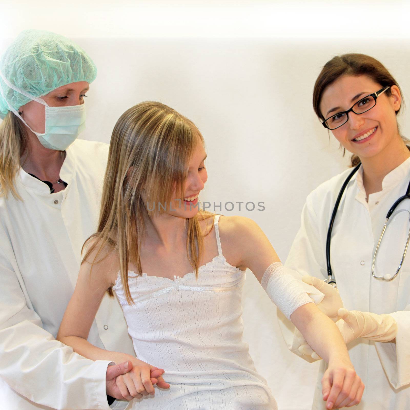 Doctors and nurses join the injured arm of a child by Farina6000