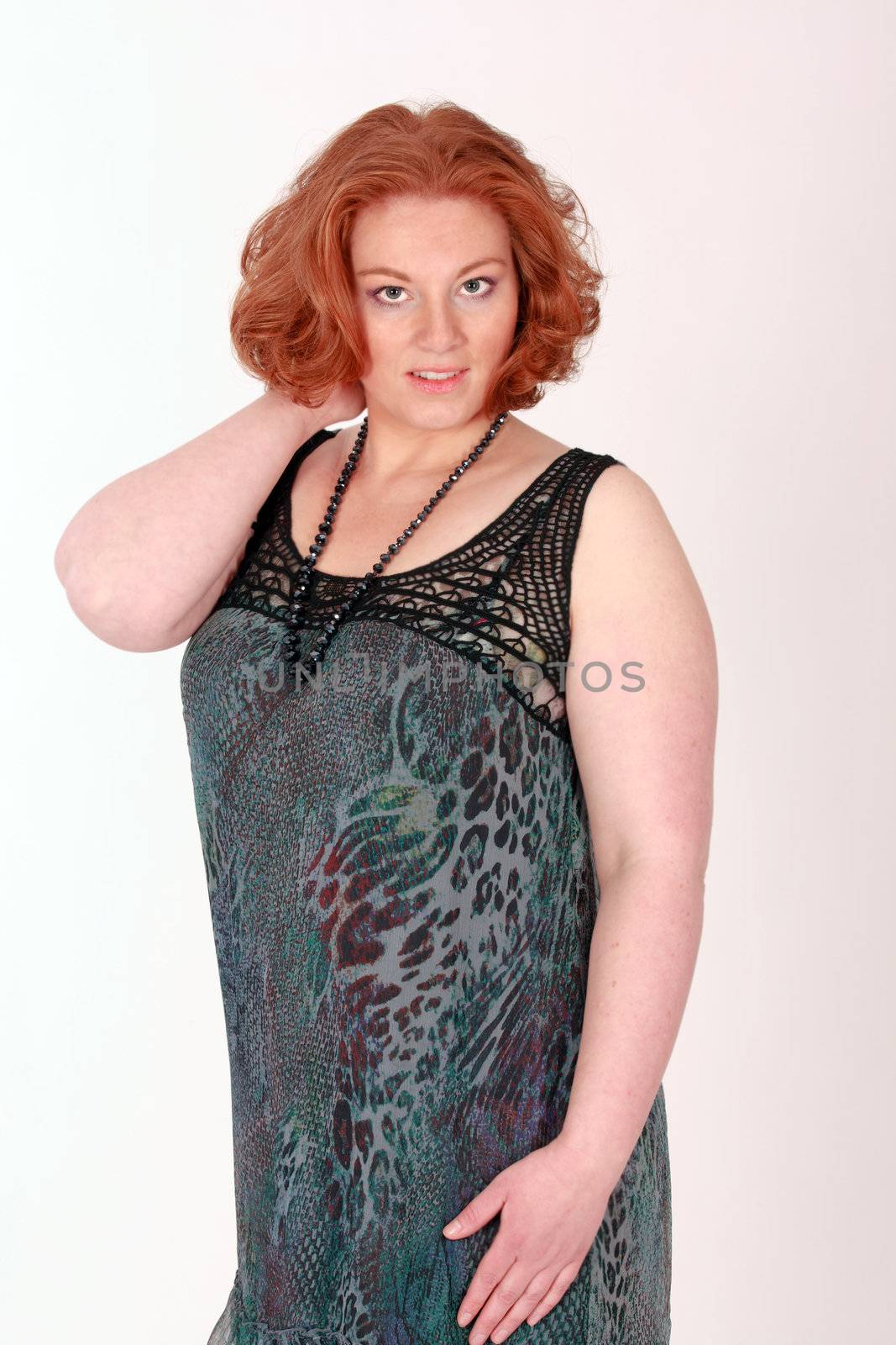 Plus Size Model with red hair in fashionable clothing