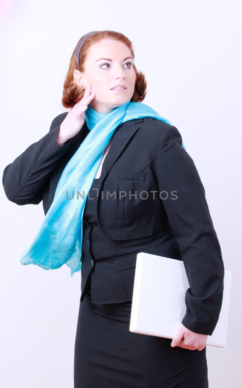 red-haired business woman with laptop in the arm