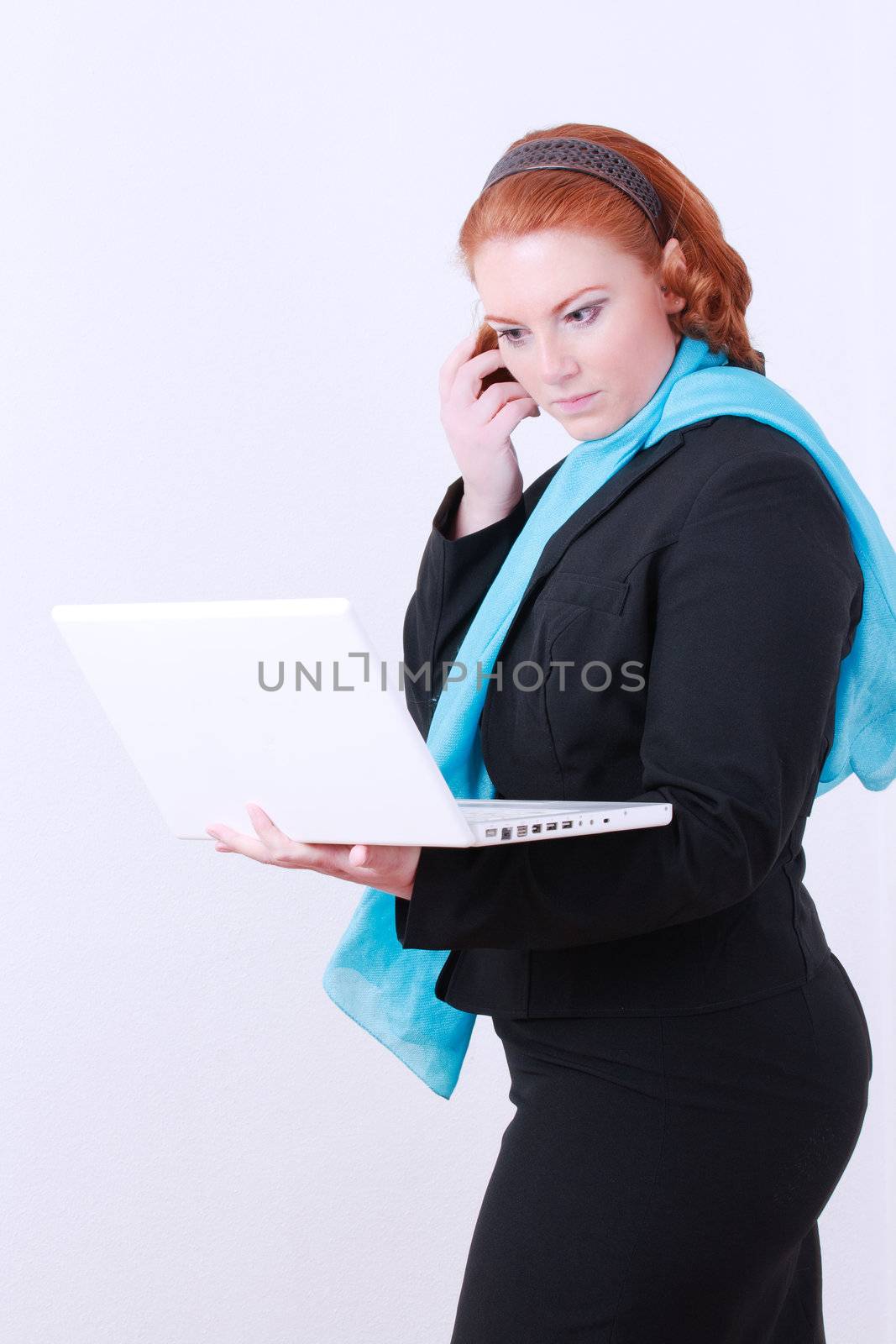 Business woman at work with laptop and mobile phones