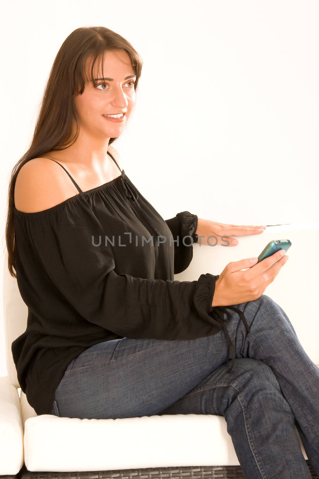 Elegant woman phoned on the couch with the phone
