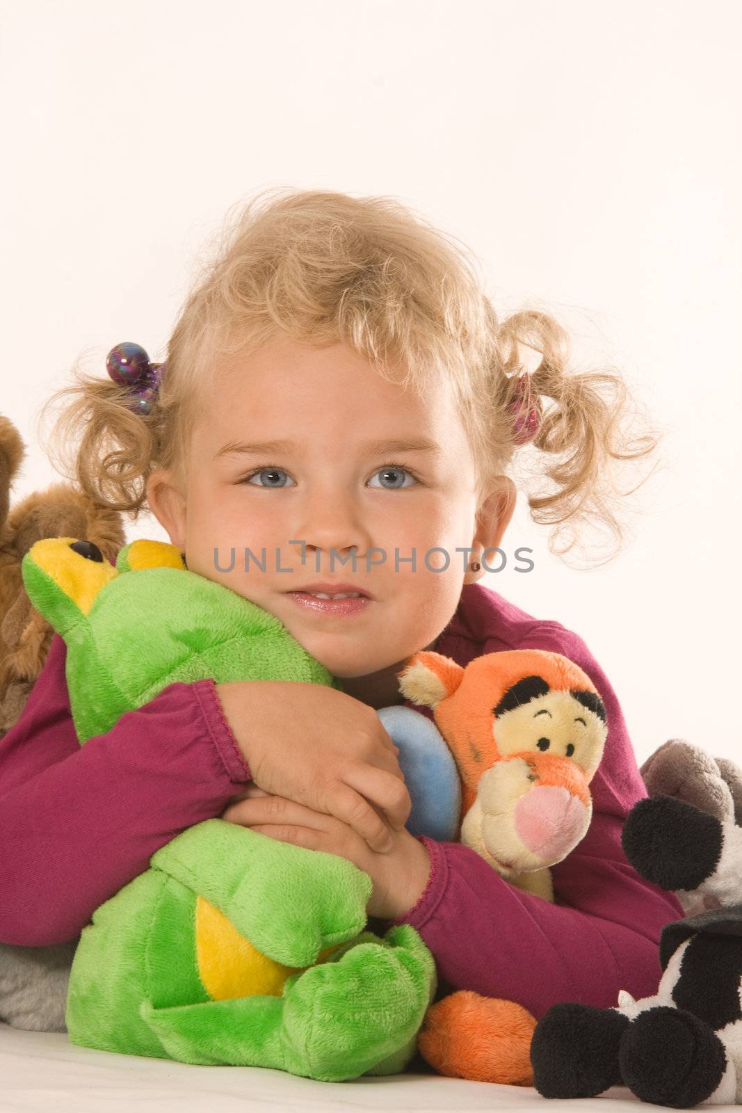 Little blonde girl with your favorite stuffed animals