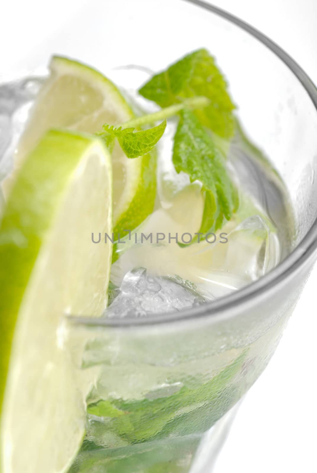 Closeup of lime in a glass of mojito with ice