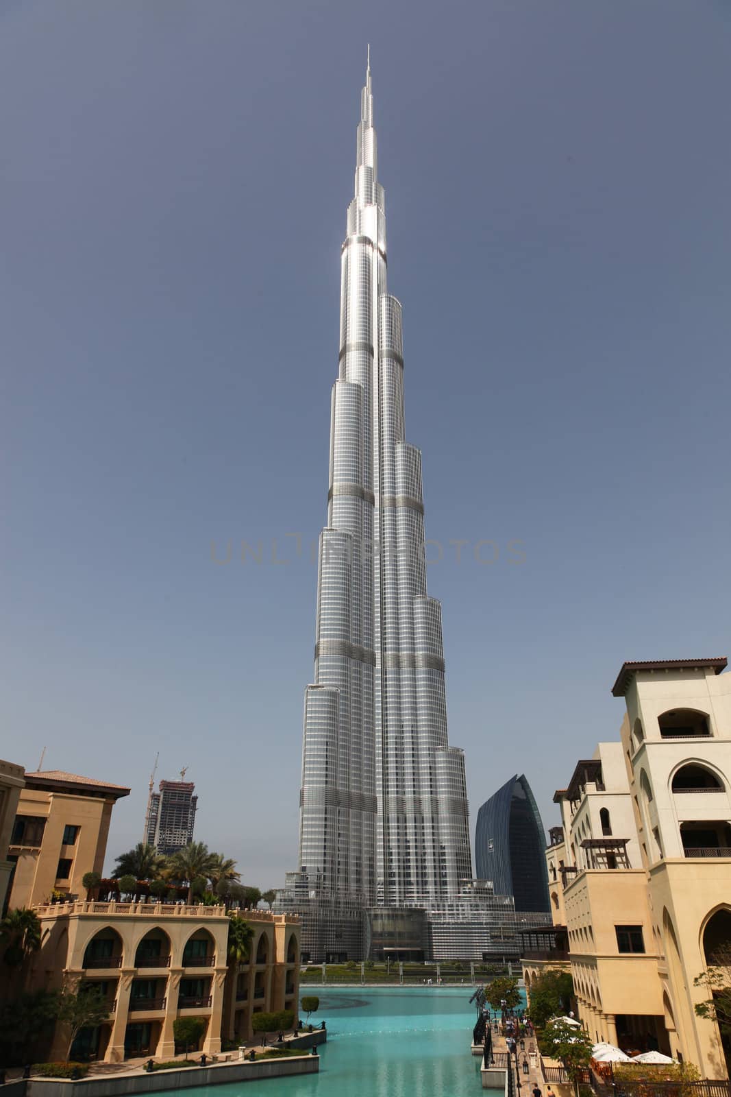 DUBAI, UAE - 2/11/2011: Burj Dubai With Water And Buildings In Front