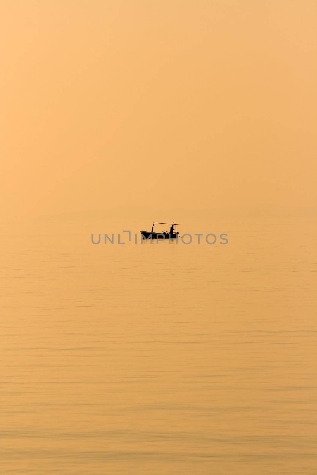 Fishing boat in the evening sun on the beach in front of Supetar on the island of Brac in Croatia