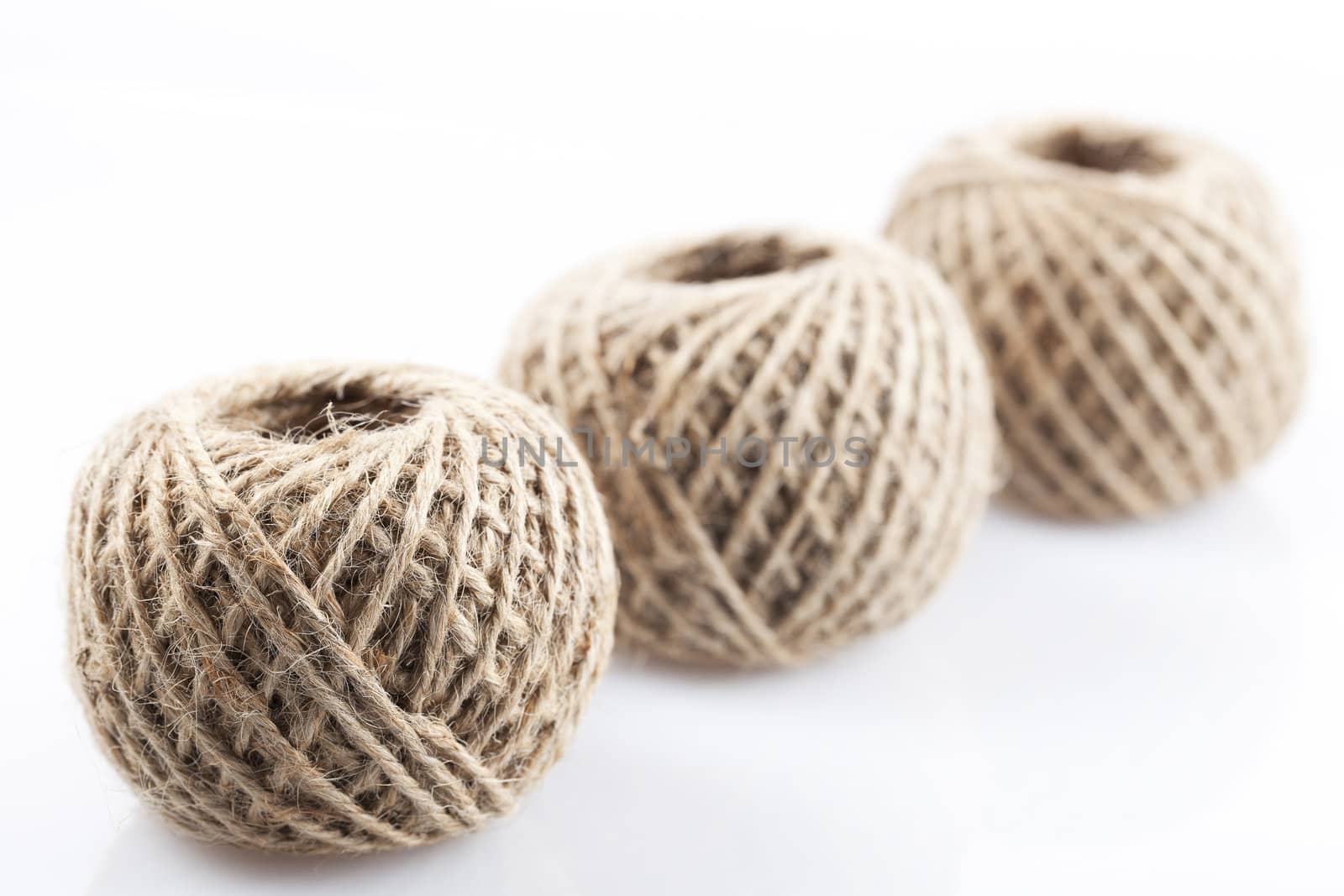Three balls of twine with focus on front twine ball.