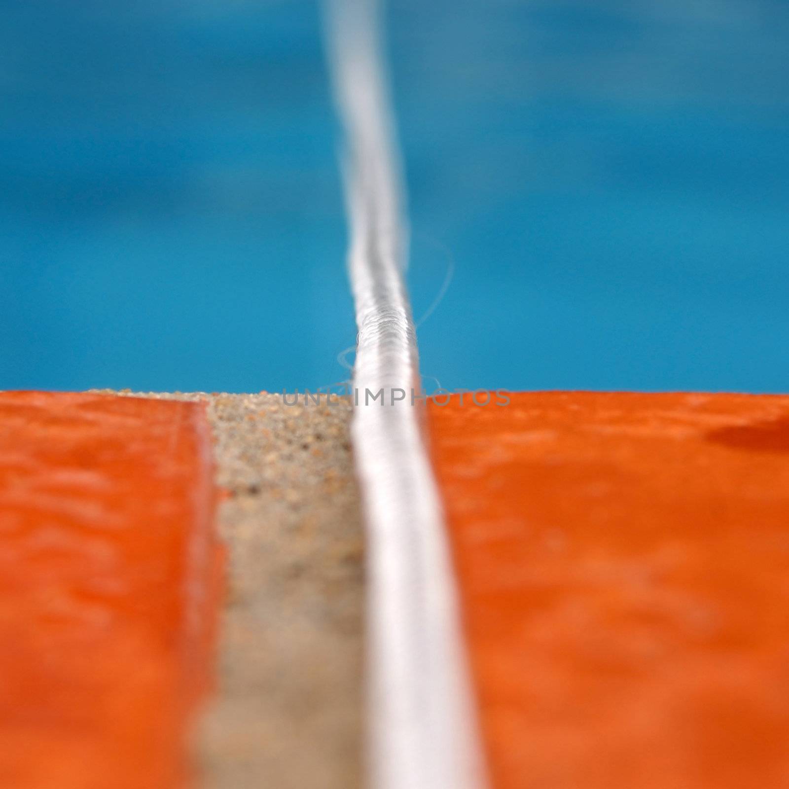 Summer concept background. White rope over swimming pool border.