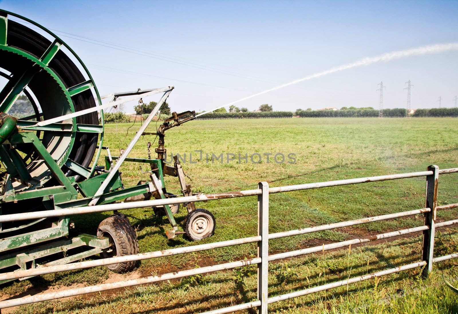 Irrigation operations in Italian country during a sunny day