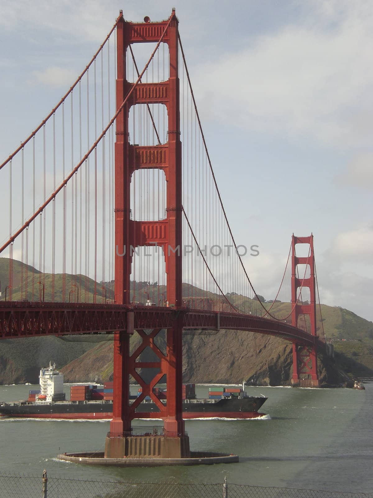 A cargo ship passes underneath the Golden Gate Bridge in San Francisco, California