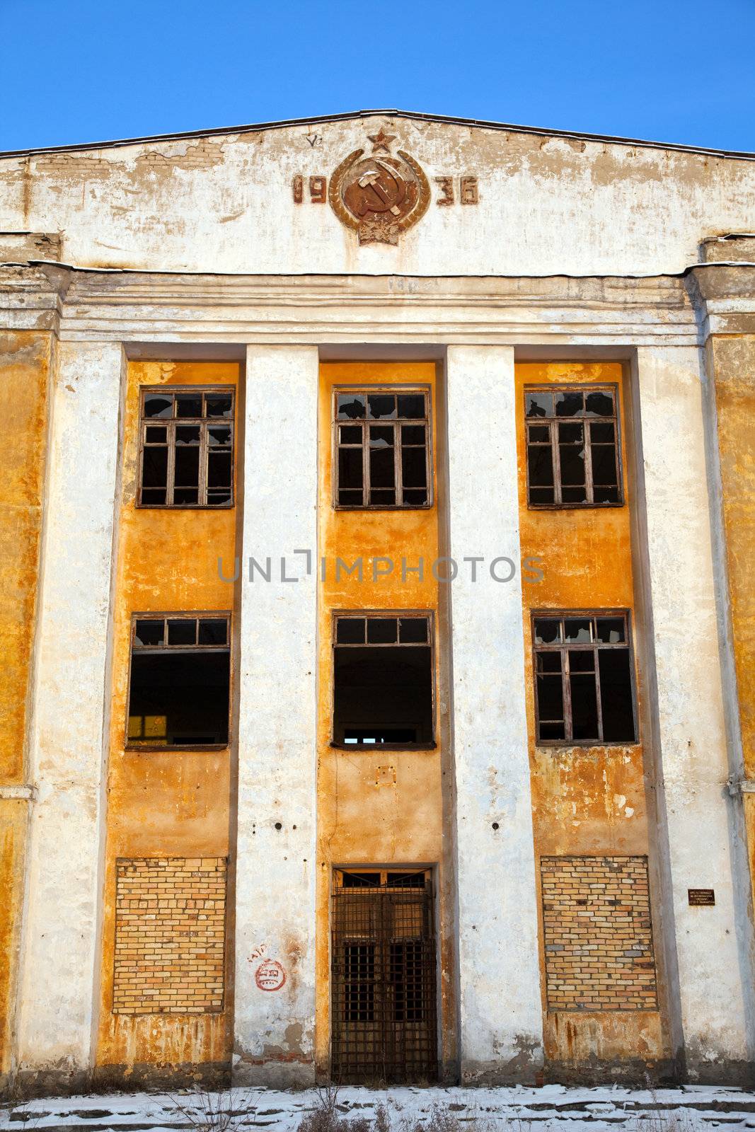 Abandoned army barracks against the blue sky