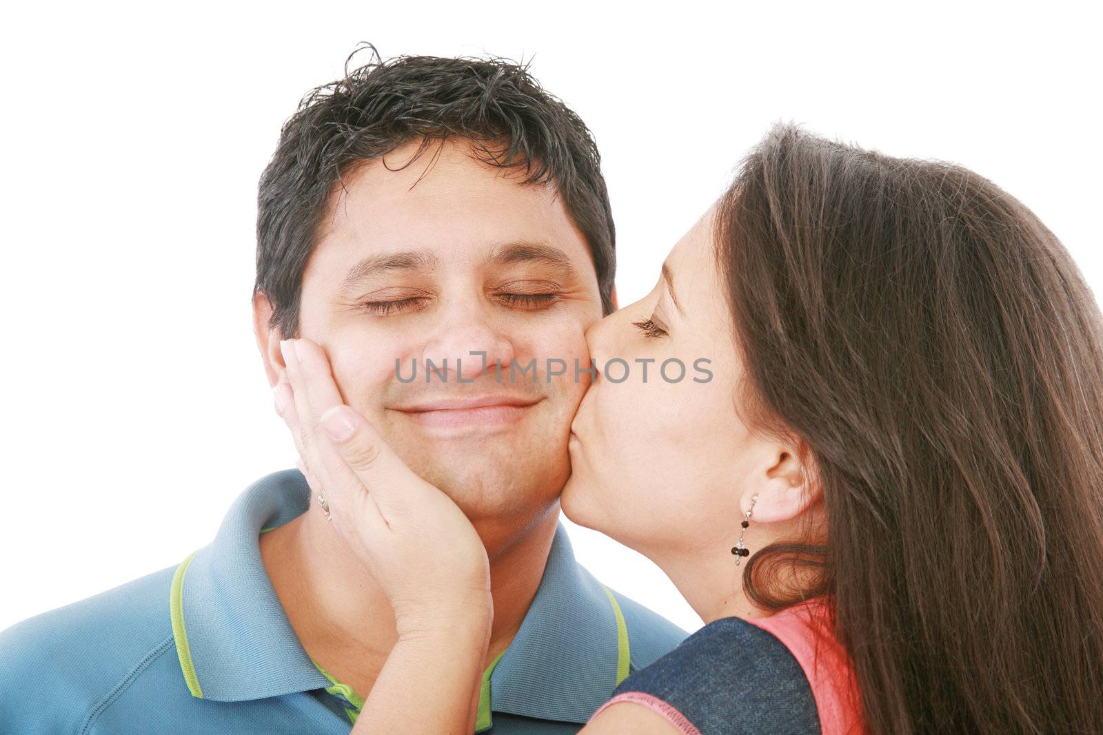 Nice girl kisses the young modest guy on a cheek