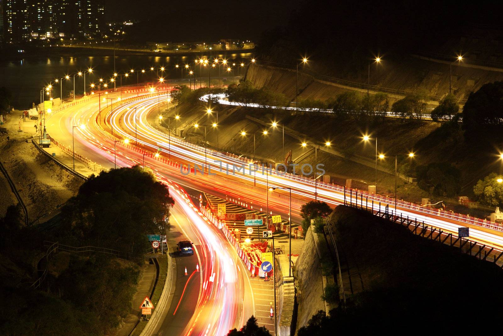 road with car traffic at night and blurry lights showing speed and motion