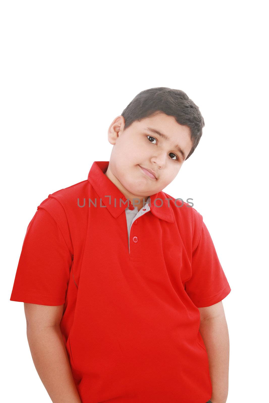 Portrait of a happy little young boy standing with hands in pocket over white background