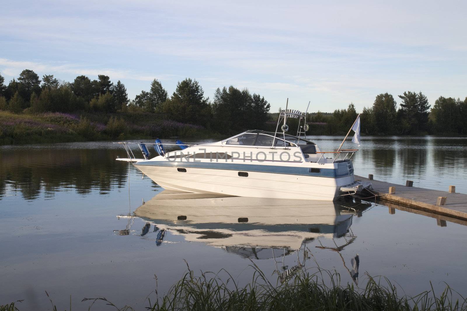 White boat on the dock. Evening Landscape