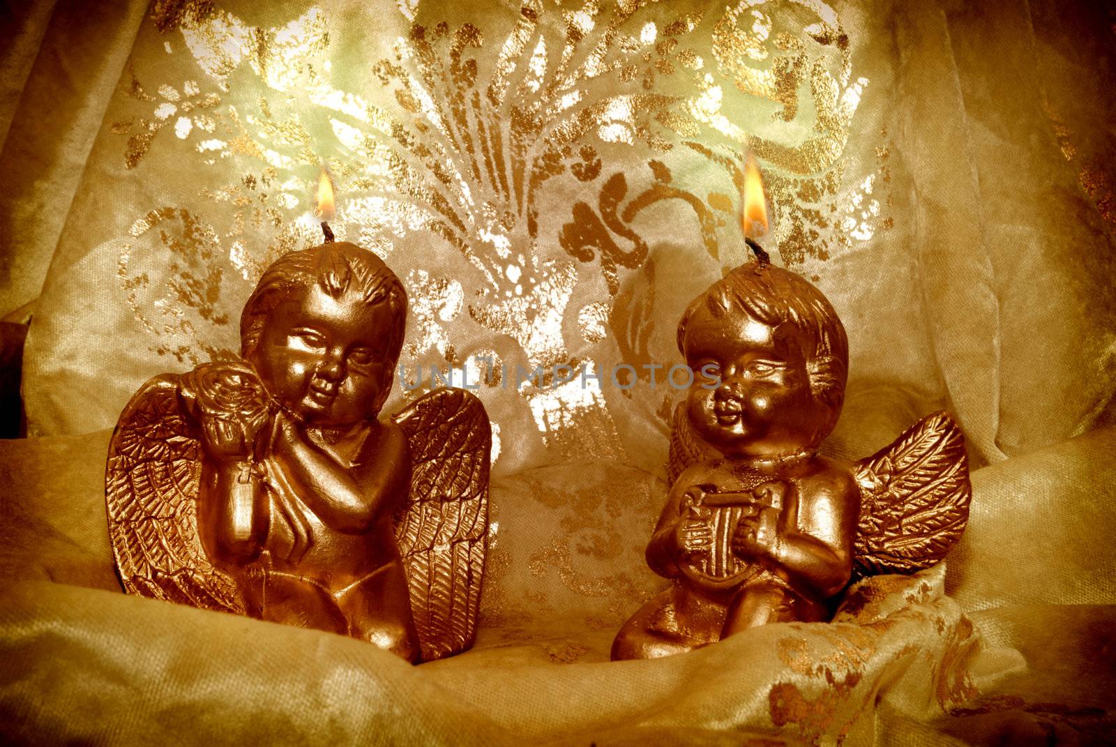 two candlelight Christmas angels with golden fabric background