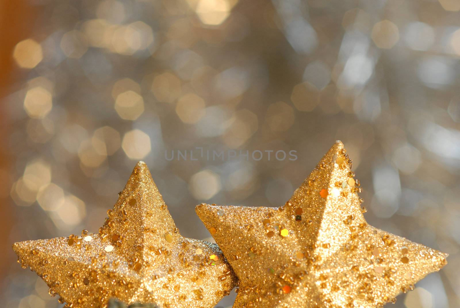 two gold stars in background blur with copyspace by Carche