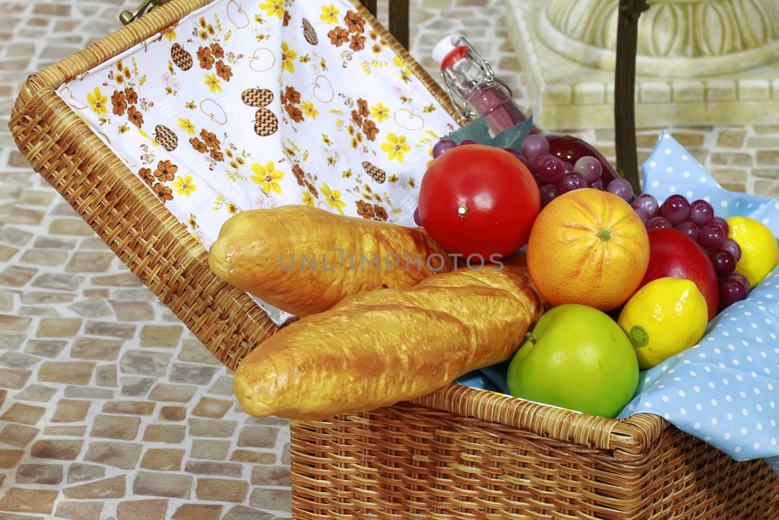 Wine and basket of fruits going for picnic.