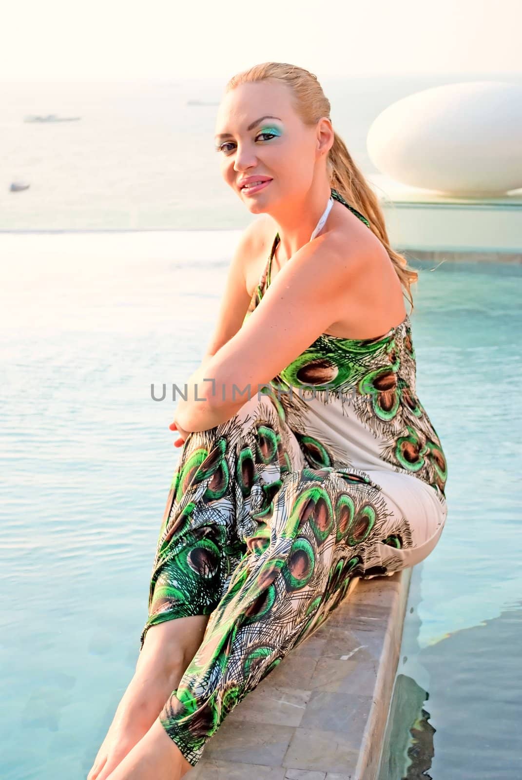 Model posing near swimming pool