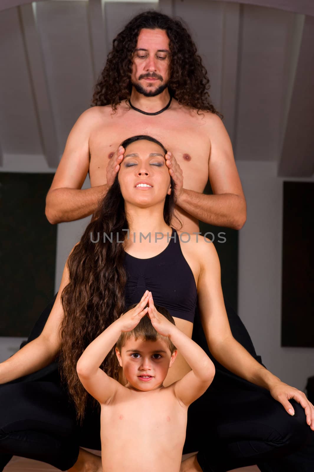 Father mother and son doing yoga exercises together