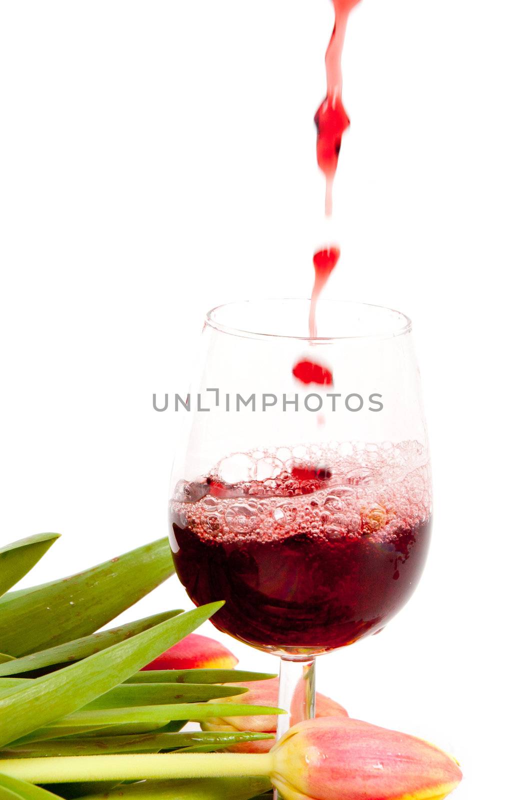 Red wine pouring into wine glass  by ladyminnie