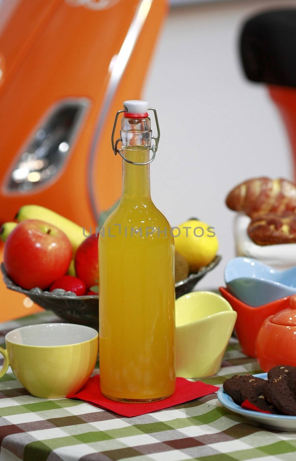 Table setting scene with a fruit wine in a bottle.