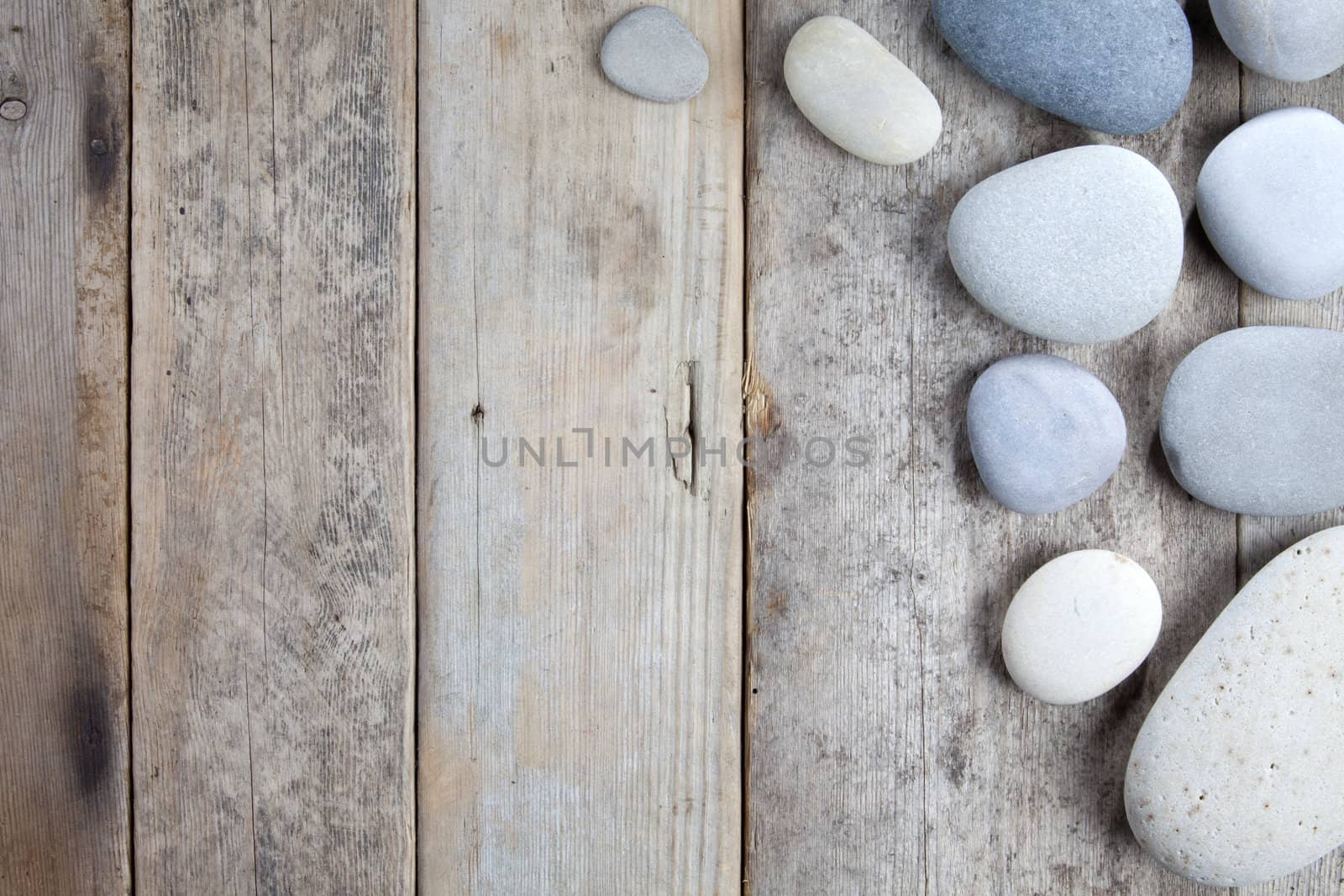 Stones with shadow on wooden background 