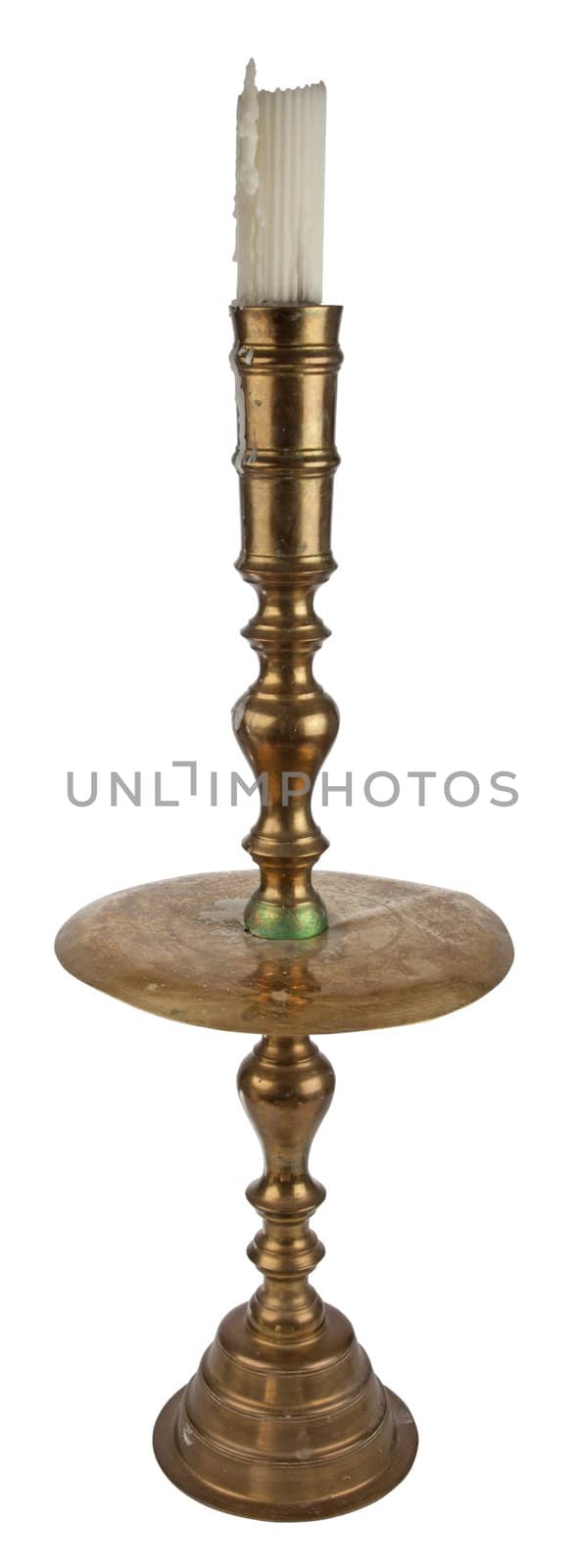 Antique brass candleholder with white pillar candle. Isolated over white. 