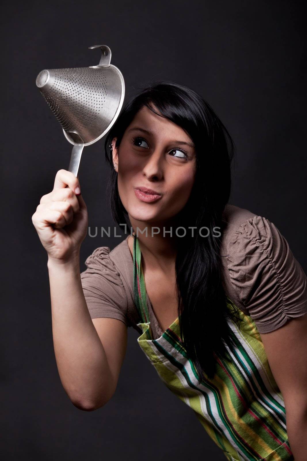 young woman looking in a sieve by bernjuer