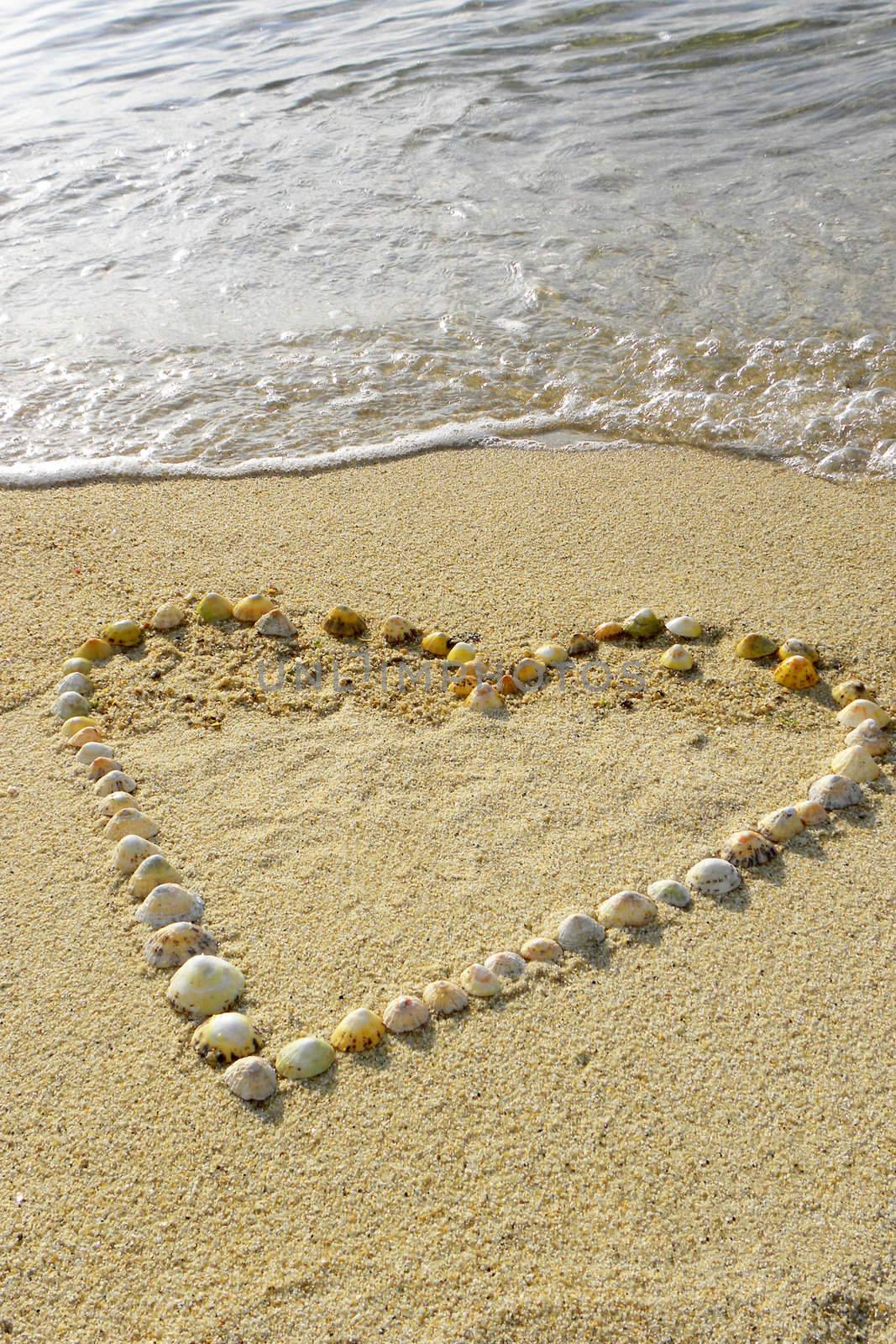 One heart in the sand with waves by Bestpictures