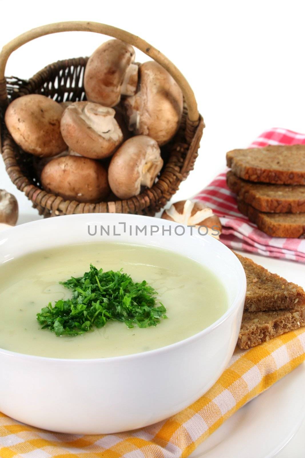 a bowl of Cream of mushroom soup with fresh ingredients
