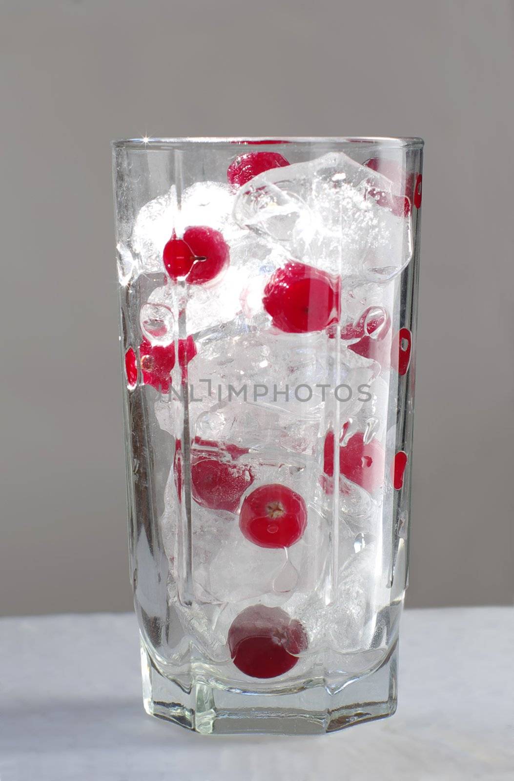 glass with blend cube ice and red berry