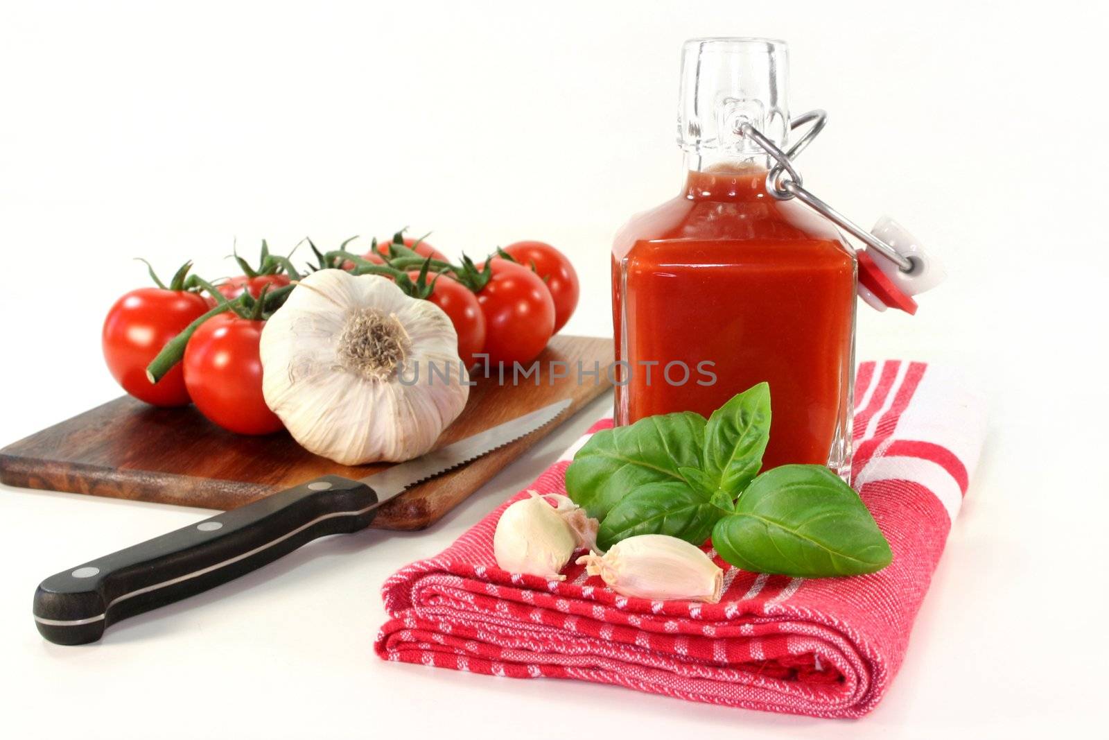 a bottle of tomato ketchup with fresh ingredients