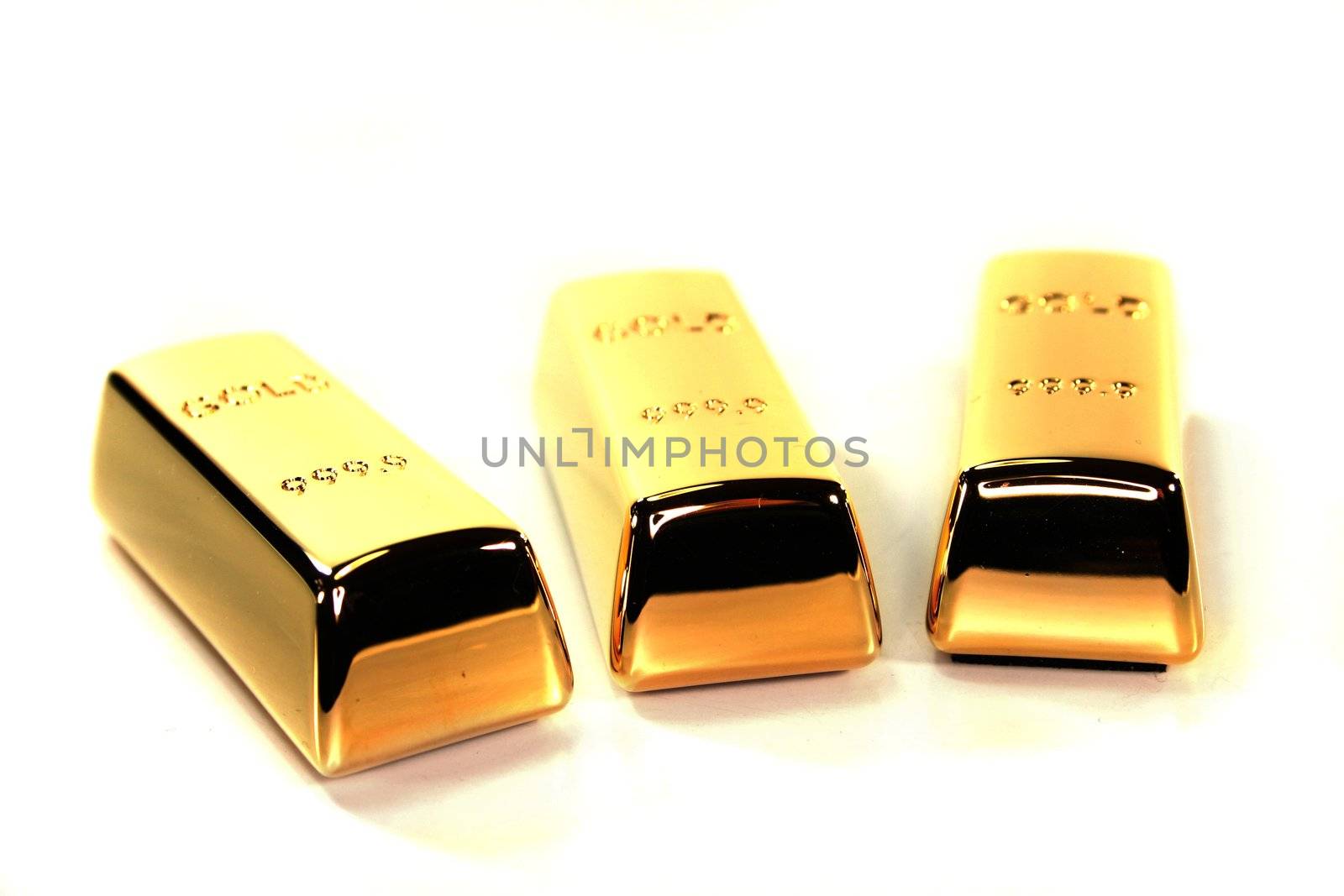 three large gold bars on a white background