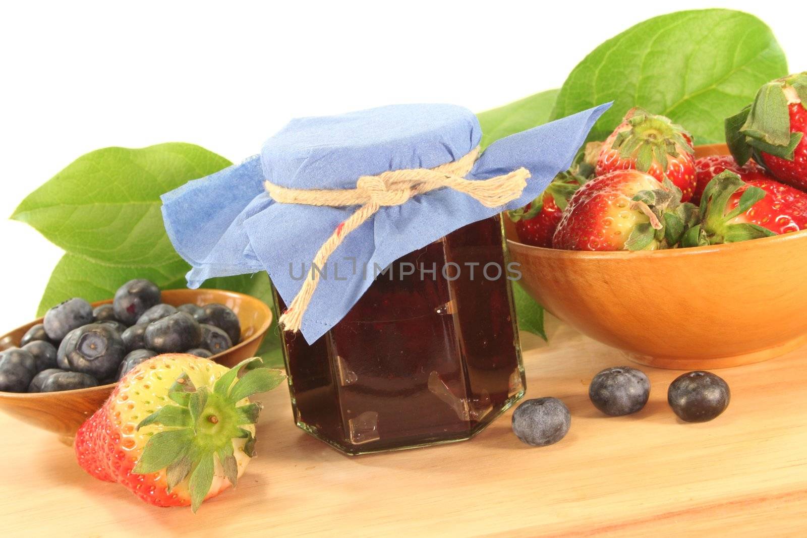 berry marmalade with different berries on a wooden board