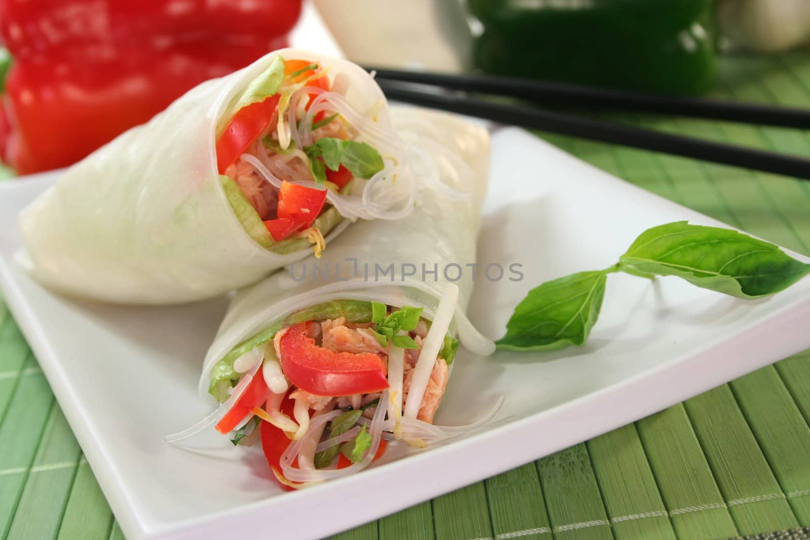 Lucky roll with lettuce, salmon, rice noodles, bell peppers and Thai basil