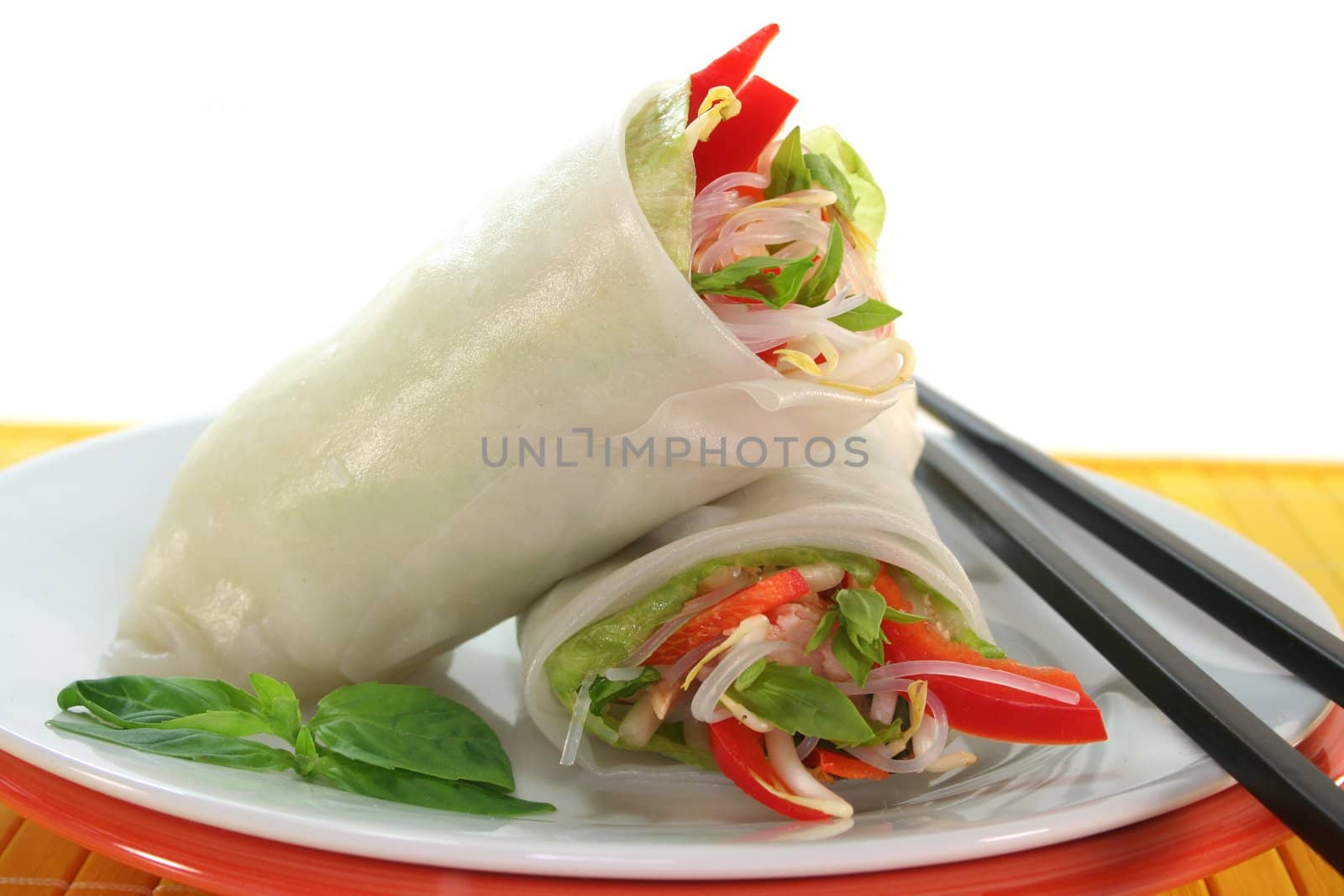 Lucky roll with lettuce, salmon, rice noodles, bell peppers and Thai basil
